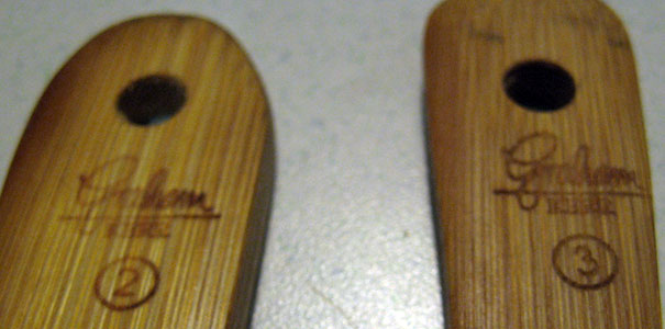 The only markings/signatures found are on the two blonde wood paddles 